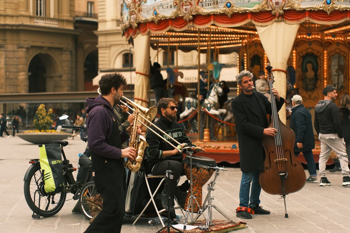 Musicians playing in front of a carousel